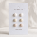 The Micro Dome Trio in Quiet Luxury — Bone, Oatmeal, Greige dome ear studs on Dimenciel branded card