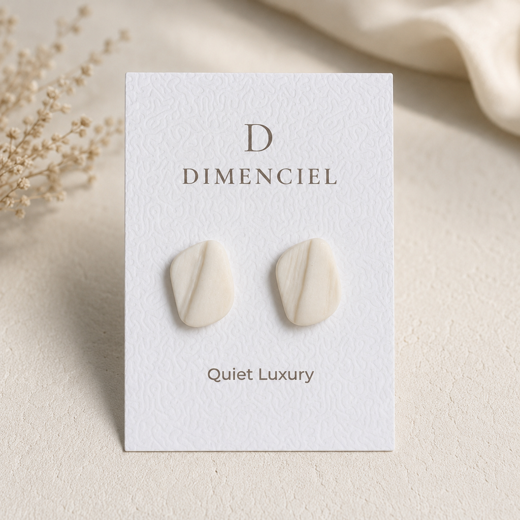 The Organic Pebble in Quiet Luxury — Bone pebble ear studs on Dimenciel branded card