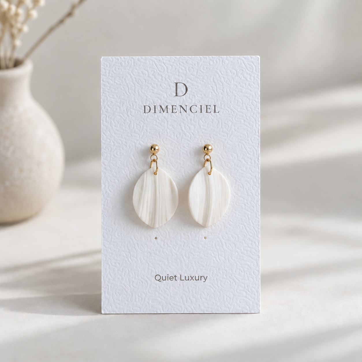 The Petal Drop in Quiet Luxury — Bone polymer clay petal drop earrings with gold hardware on Dimenciel branded card