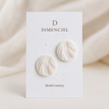 The Swirl Orb in Quiet Luxury — Bone circle ear studs with swirl texture on Dimenciel branded card