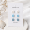 Coastal Blues Square Ear Studs Set — three pairs of square studs in white, sky blue, and slate blue on a Dimenciel branded card