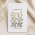 Botanical Sage Lilac Ear Studs Set — three pairs of flower studs in ivory, sage, and dusty teal on a Dimenciel branded card