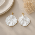 Pair of white round scalloped petal earrings